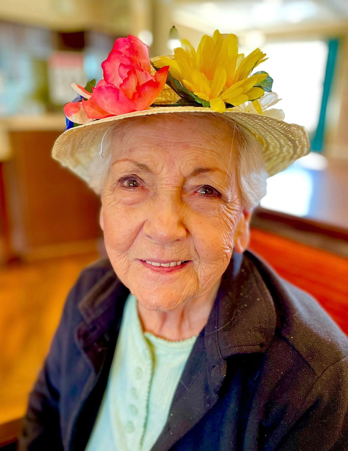 Senior resident wearing a flower hat