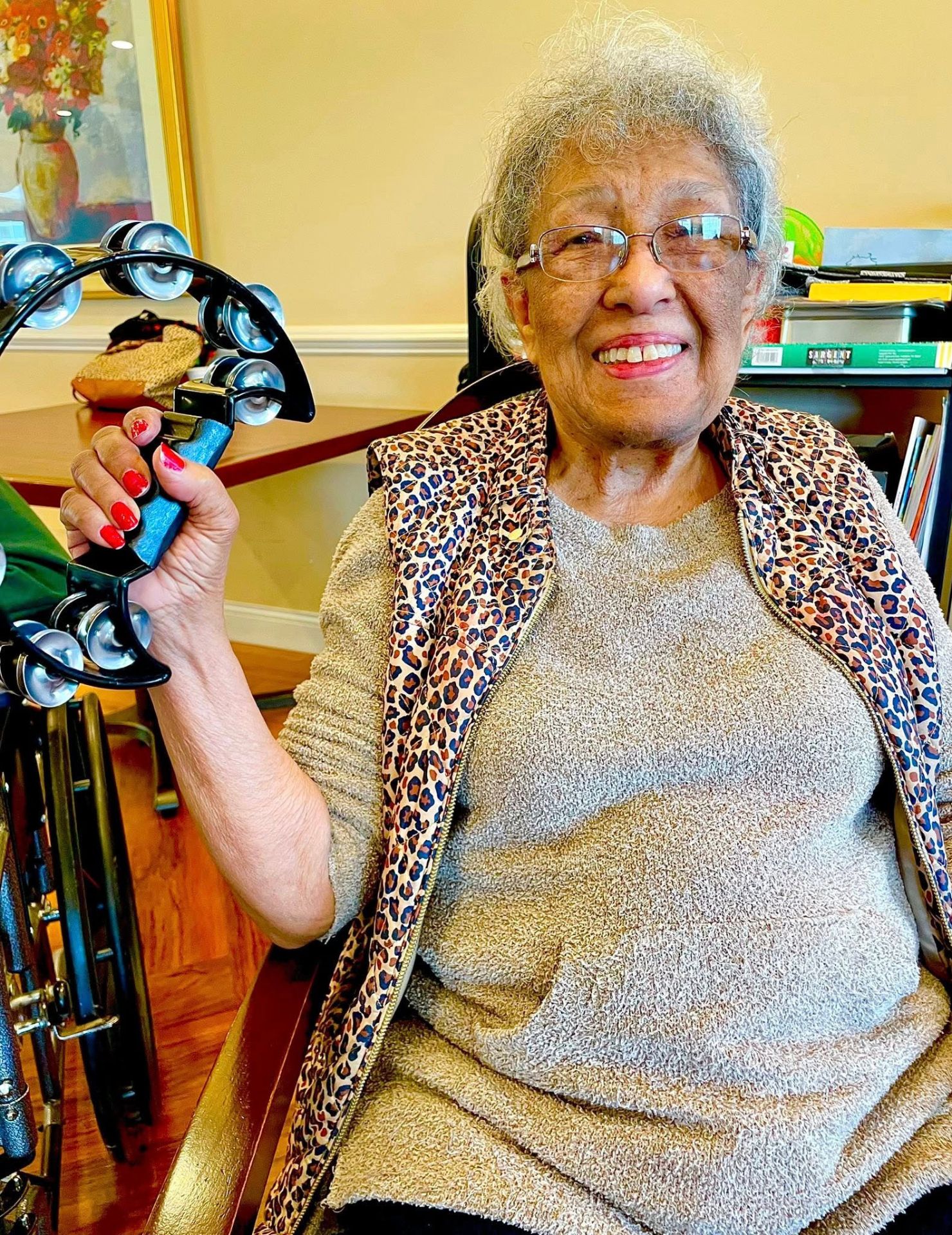 Senior resident playing tambourine